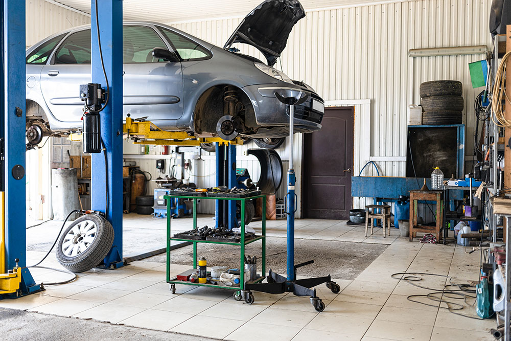 car-is-lifted-on-hydraulic-lift-in-car-workshop-2026-01-05-05-10-00-utc